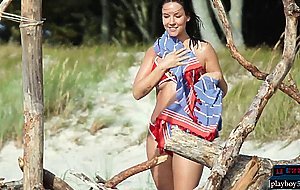 German MILF model Joelina strips naked on the beach