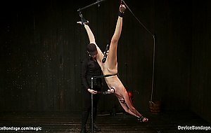 Redhead in inverted bondage toyed