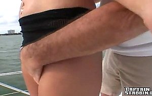 Busty blonde Cassandra gives head to captain on his boat