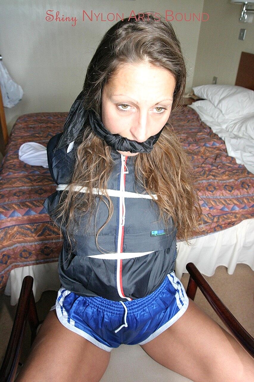 Clothed female briefly manages to remove her gag while tied to a chair