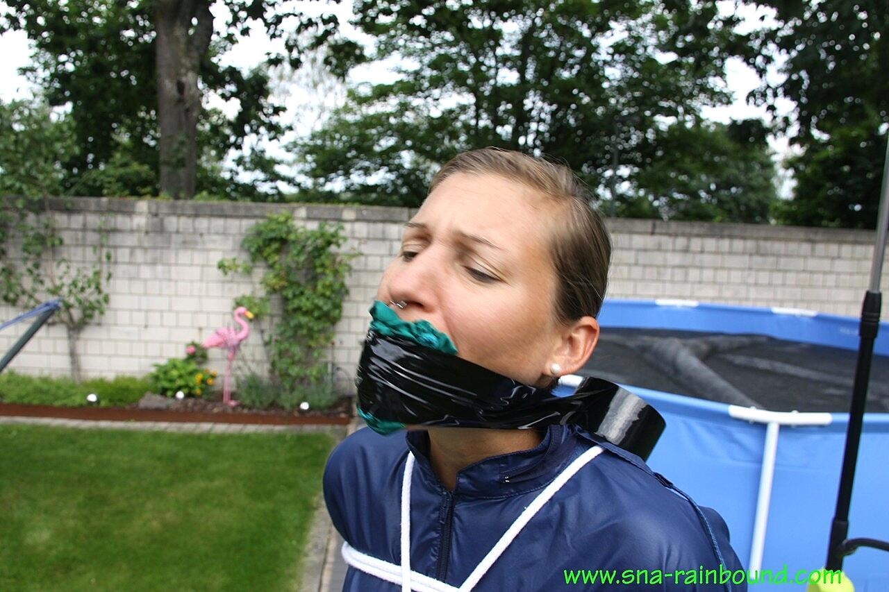 White girl is left tied up in rainwear with her panties stuffed in her mouth