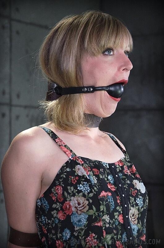 Clothed female Mona Wales finds herself being restrained in a dungeon